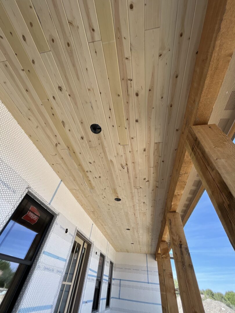 A closeup look at the newly made ceiling of a wooden porch